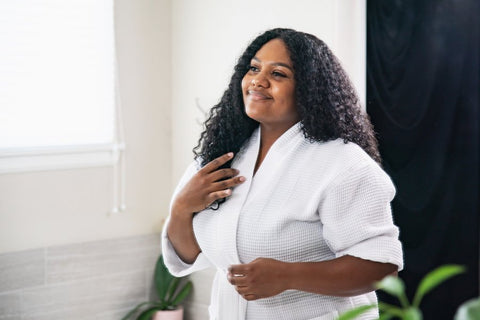 woman in bathrobe smiling